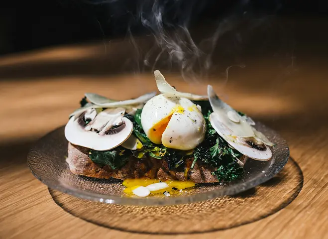 A plate of food with mushrooms on top